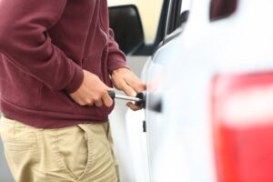 Man trying to unlock his car the wrong way