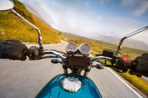 Motorcycle driver riding in the summer