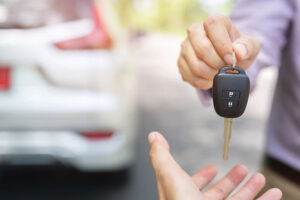 Man handing another man car keys