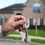 Man hand holding on finger keys to new house
