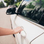 Woman trying to open a locked car door
