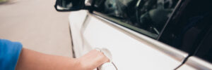 Woman trying to open a locked car door