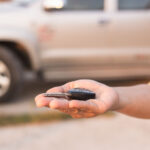 closeup of a hand handling a car key that isn't working