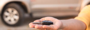 closeup of a hand handling a car key that isn't working