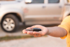 closeup of a hand handling a car key that isn't working
