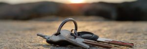 Lost car keys on pavement under a sunset