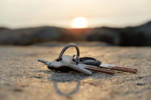 Lost car keys on pavement under a sunset